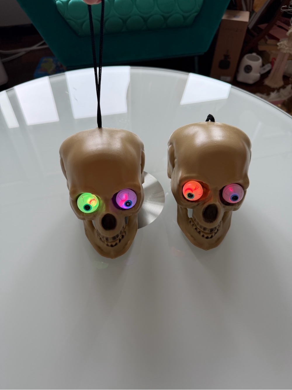 vintage plastic Halloween skull decoration featuring bulging, animated blue eyes